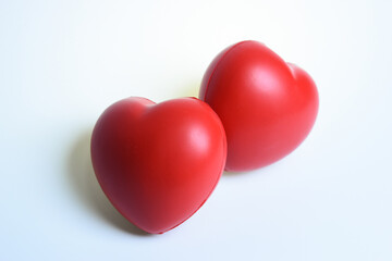 two red stress ball isolated on white background, heart shape toy