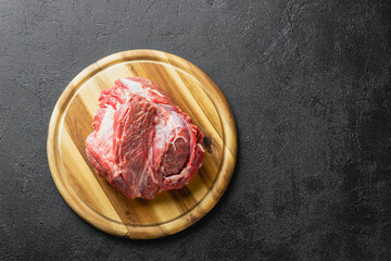 Raw beef meat on a wooden cutting board