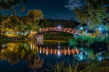 Naklejka premium A scenic night view of a countryside bridge over a calm, reflective river