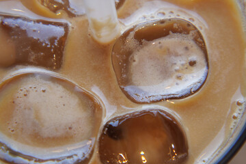 Close up of ice cubes in a glass of coffee, 