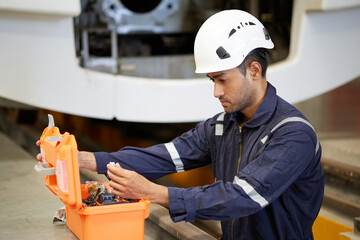 Technician or engineer opening tool box for fixing the train at construction site