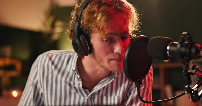 Microphone, man or influencer talking on podcast, recording or night broadcast with radio host dj. Live streaming, headphones or streamer with script for online interview or discussion on technology