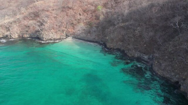 Drone view of the exotic turquoise Playa Penca beach in Guanacaste, Costa Rica