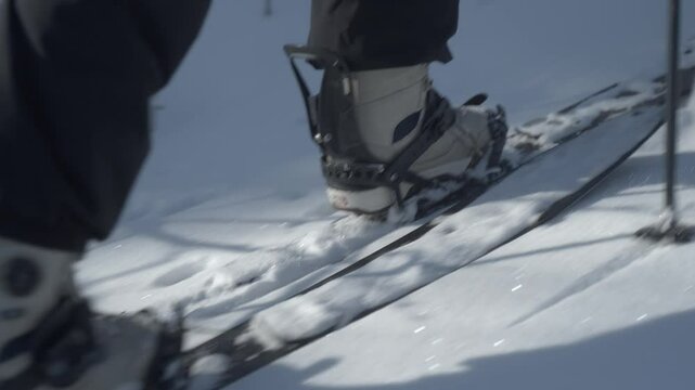 A person wearing ski boots using a splitboard in snowy Hokkaido, Japan