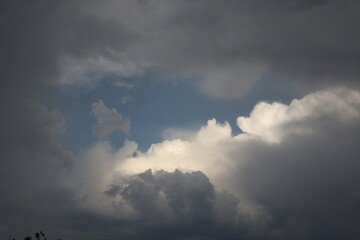 Dramatic sky with sunlight breaking through stormy clouds, creating a striking contrast