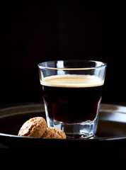 Coffee in glass cup on dark background. Close up. Copy space