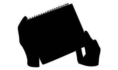 silhouette of hands holding loose-leaf paper