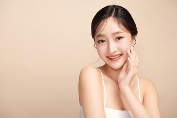 Beautiful young asian woman with clean fresh skin on beige background, Face care, Facial treatment, Cosmetology, beauty and spa, Asian women portrait.