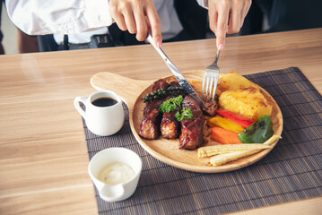 Businessman eat Steak having lunch at a restaurant. Ribs eye steak with mashed potato, salad cream French fries Barbecue Grill and Spaghetti, Happy man sitting have dinner enjoying food