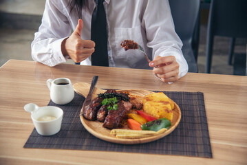 Businessman eat Steak having lunch at a restaurant. Ribs eye steak with mashed potato, salad cream French fries Barbecue Grill and Spaghetti, Happy man sitting have dinner enjoying food