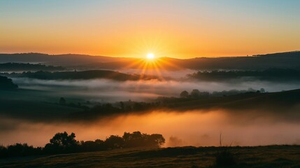 Fototapeta premium A beautiful sunrise over a misty valley.