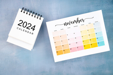 November 2024 calendar page with on wooden background.