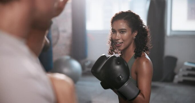 Fitness center, boxing and coach with woman for punch, exercise and training class. Gym, female client and male personal trainer for supervision, teaching and motivation for beginner boxer or fighter