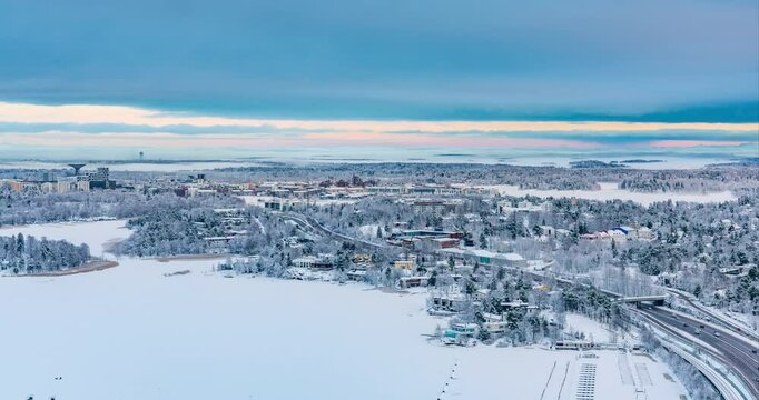 Timelapse of a dark winter evening above the snowy Kulosaari island in Helsinki