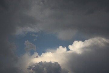 Dramatic sky with dark clouds and sunlit patches creates striking contrast in weather