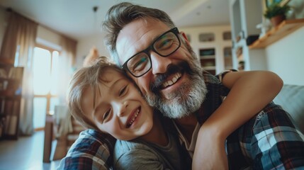 Little boy making selfie on smartphone with father,lying on floor in kids room,making silly faces. Dad explaining technology to son,digital literacy for kids.