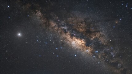 A starry night sky with a large cloud of dust and gas