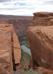 Looking down at Colorado river from the steep crack on Horseshoe bend canyon edge