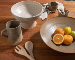 Rustic still life with orange and lemon, pitcher and ceramic bowl