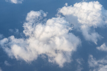 Clouds photographed from an airplane，Cumulus clouds are clouds that have flat bases and are often...