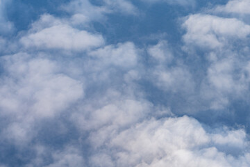Fototapeta premium Clouds photographed from an airplane，Cumulus clouds are clouds that have flat bases and are often described as puffy, cotton-like, or fluffy in appearance. Honolulu to Lihue
