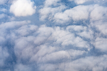 Clouds photographed from an airplane，Cumulus clouds are clouds that have flat bases and are often...
