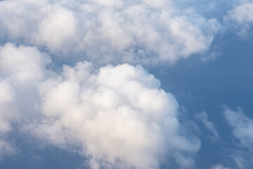 Clouds photographed from an airplane，Cumulus clouds are clouds that have flat bases and are often described as puffy, cotton-like, or fluffy in appearance. Honolulu to Lihue