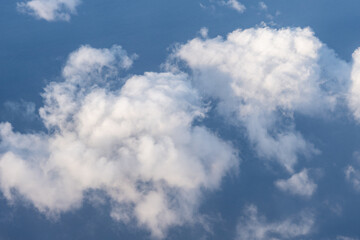 Clouds photographed from an airplane，Cumulus clouds are clouds that have flat bases and are often described as puffy, cotton-like, or fluffy in appearance. Honolulu to Lihue