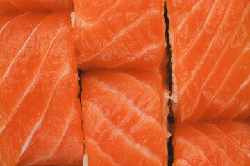 A close-up image of freshly made salmon sushi rolls