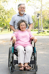 Asian healthy senior couple relaxing in the park together.