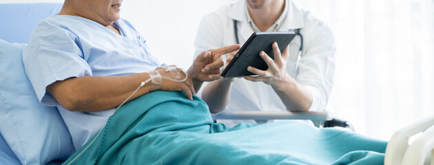 happy elderly looking at a good result of health check up in the medical chart with doctor.