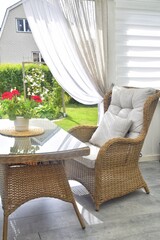 Relaxation area. Wicker chair and table on the terrace.