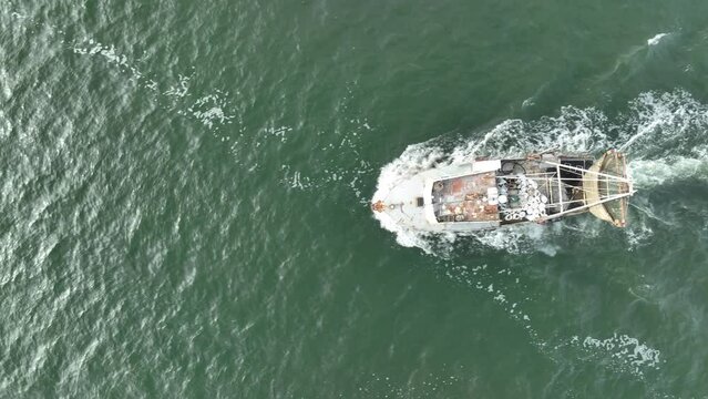 Aerial view of trawler vessel. Fishing boat trauler with sacks full of rapani