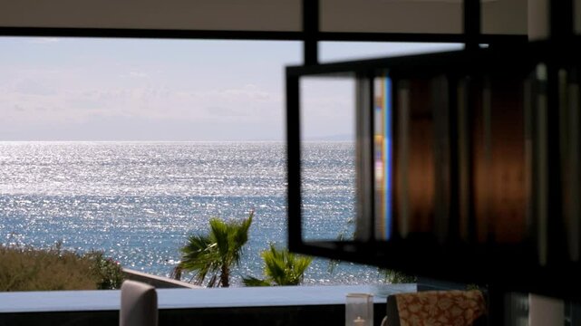Slow motion revealing shot of a beautiful sea view from a villa in Sete, France
