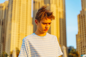 Handsome teenager 16 -18 years old Male High School Student. Sad teenage boy on the way to college. Close up emotional portrait of caucasian young man