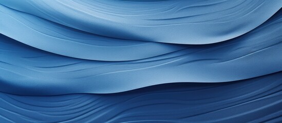 A close up copy space image of a textured blue paper background