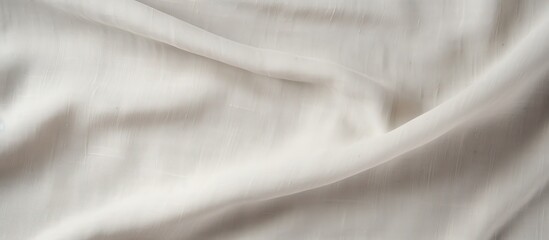 An artistic grey wale linen canvas acts as the background for a mock up template of a cream abstract cotton towel This cloth can be used as a blanket curtain or for text decoration purposes