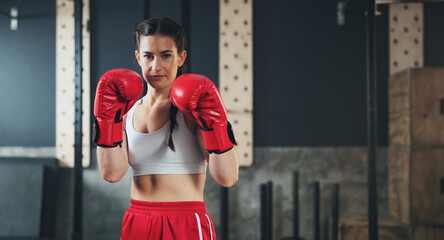 Portrait, gym and boxing glove with workout, woman and practice for match and sports with...