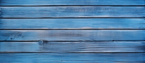 Obraz premium A blue panel with a wood texture creates a captivating background in this copy space image