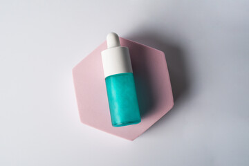 Blue cosmetic bottle, Skin care or sunscreen cosmetic with stylish props on white background.
