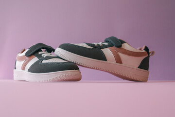 Children's sneakers on a pink background, style and fashion