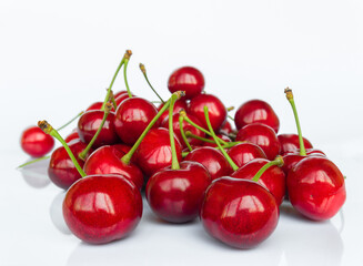 Sweet cherry fruit (Prunus avium) close-up on white background with reflection