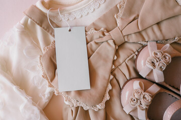 Top view flat lay beige children dress on beige background
