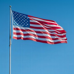 Obraz premium Majestic American Flag Waving in Clear Blue Sky