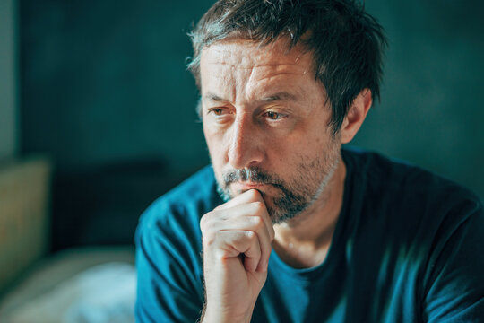 Bemused man, preoccupied and deeply absorbed in thoughts