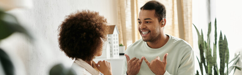 A couple communicates using sign language in their home. © Bliss