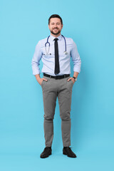 Full length portrait of smiling doctor on light blue background
