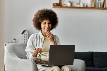 A woman smiles while using sign language on a video call.