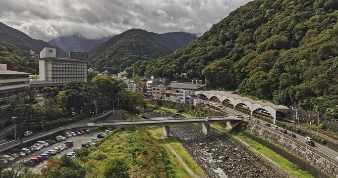 Hakone Japan Aerial v1 low flyover along the Haya river captures Yumoto train station and a small hot springs resort town nestled in the mountains - Shot with Mavic 3 Pro Cine - October 2023