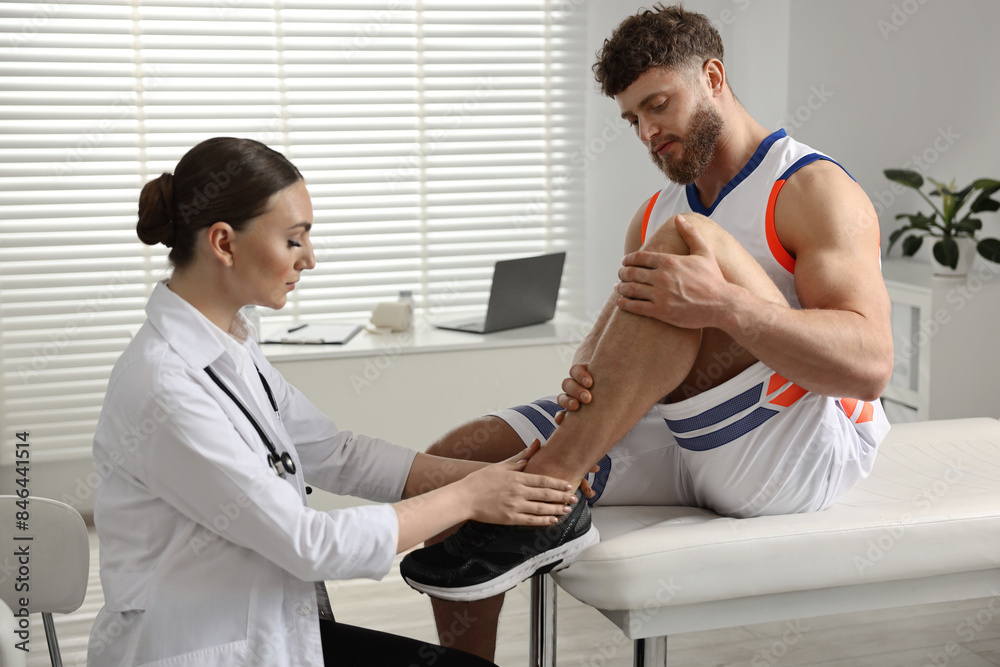 Sticker Sports injury. Doctor examining patient's leg in hospital